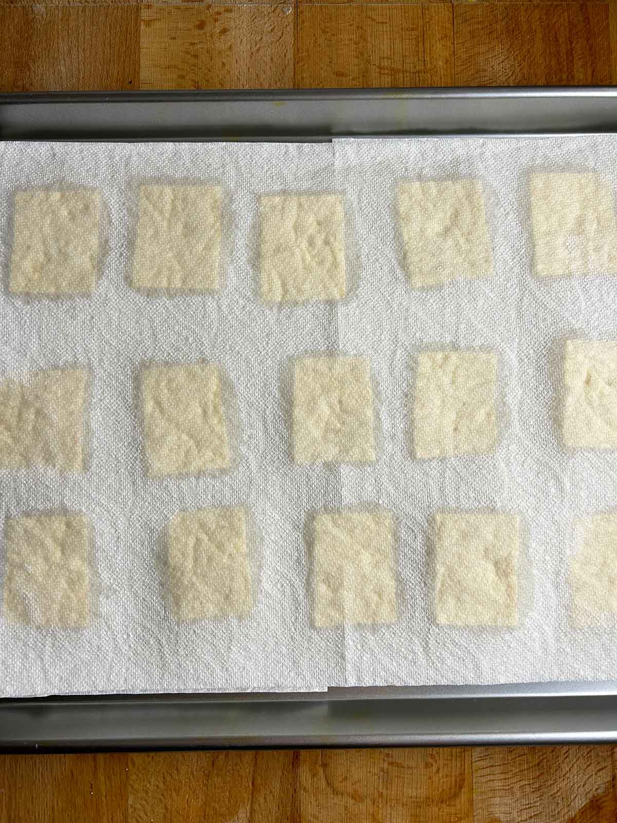 sliced tofu drying on paper towels