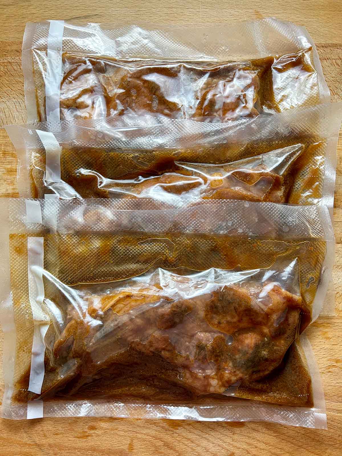 cooked pork shoulder strips in sous vide bags