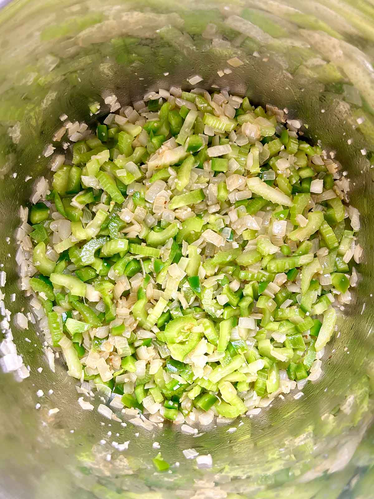 sautéing green peppers and celery in pot