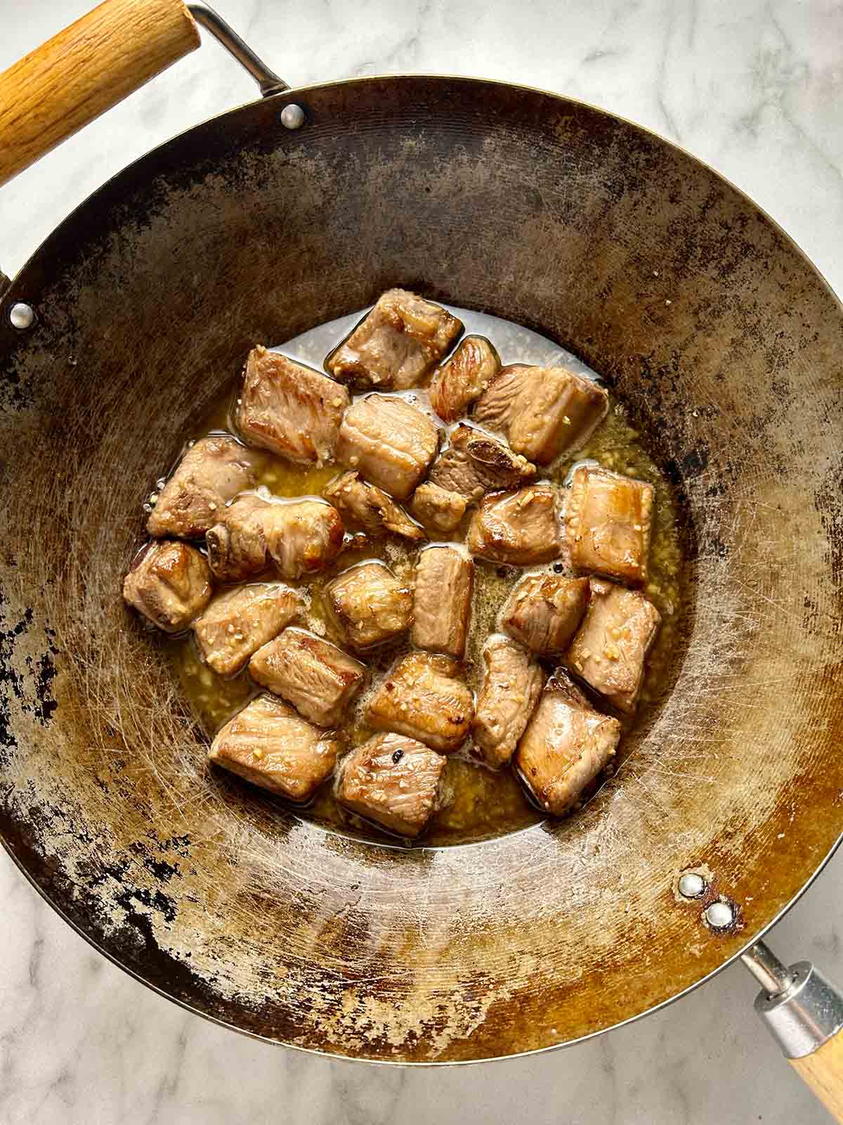 ribs simmering in sauce in wok
