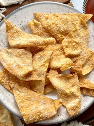 top down view of wonton chips on plate with side of sweet and sour sauce