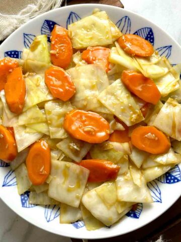 overhead shot of carrots and cabbage stir-fry on plate.