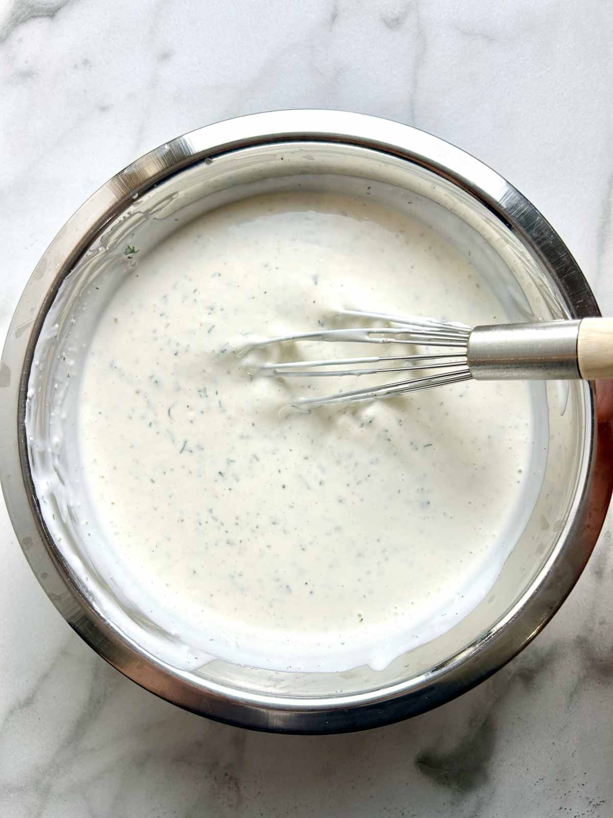 ingredients being whisk in bowl