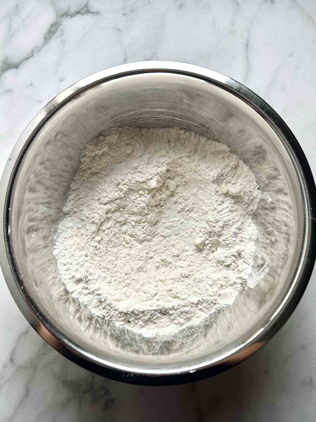 butter being cut into dry ingredients