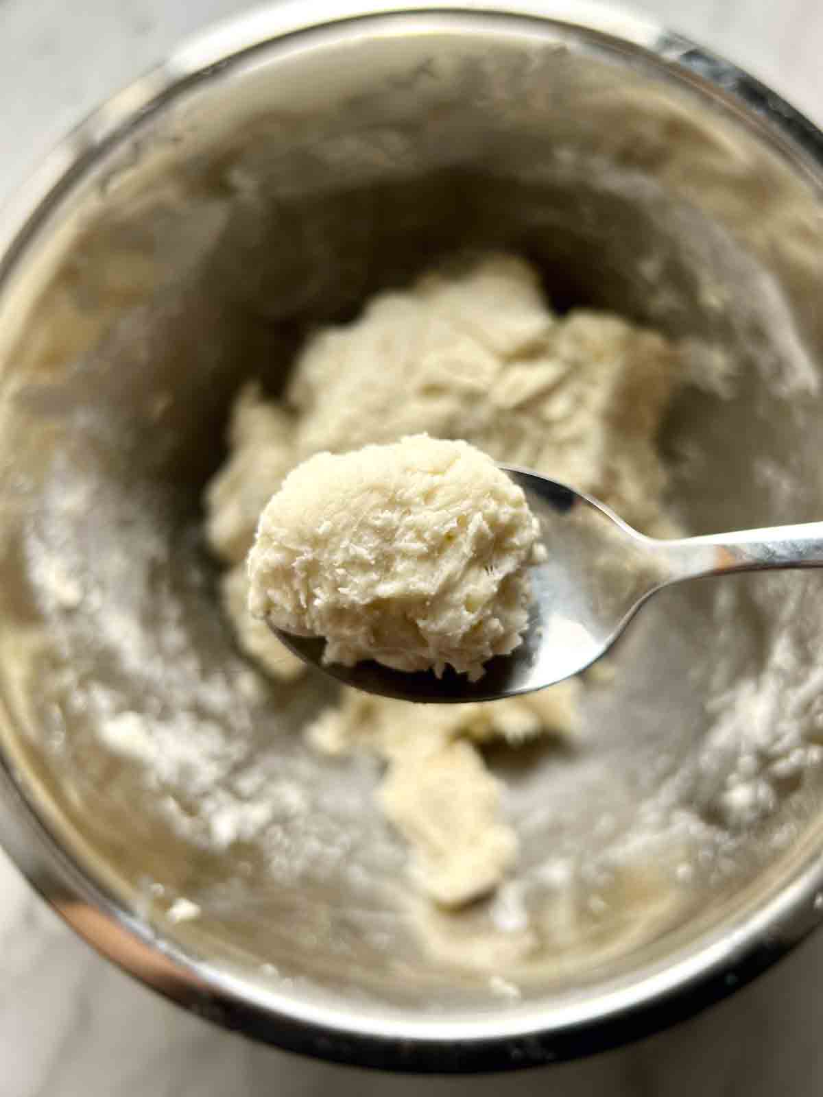 spoon holding small piece of dough