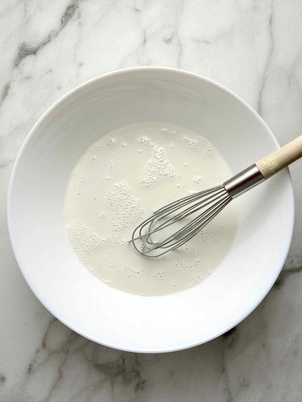 glutinous rice flour, sugar, and water whisked in a bowl