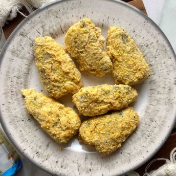 overhead shot of fried canned sardines on plate.