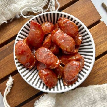 overhead shot of air-fried Chinese sausages in bowl.