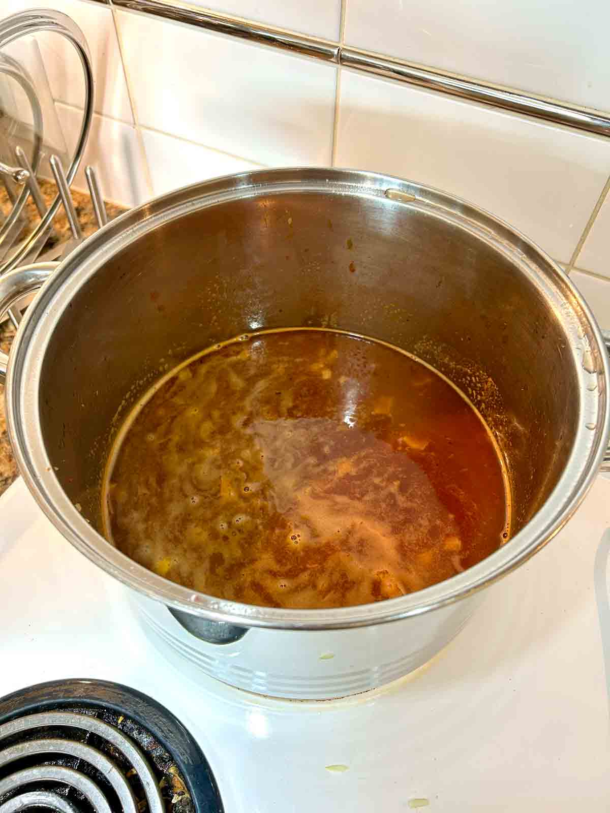 pot being deglazed with red wine, beef broth, and Worcestershire sauce.