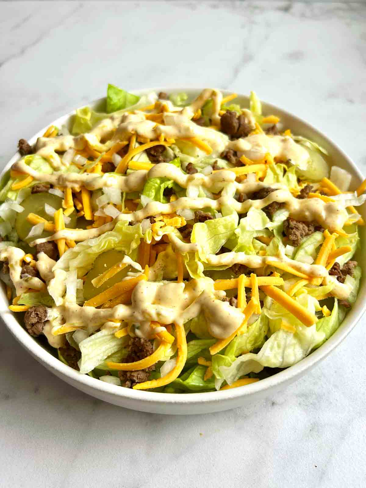 side shot of big mac salad in bowl.