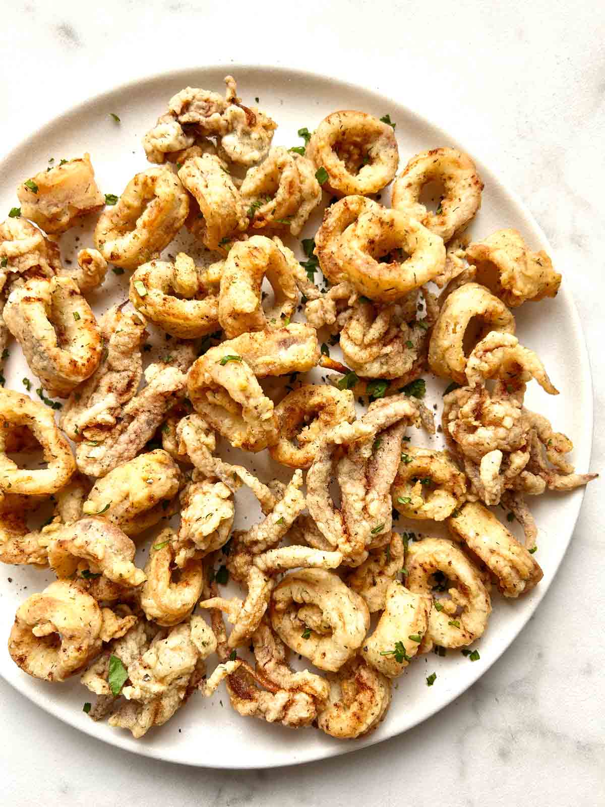 close up of fried calamari on plate.