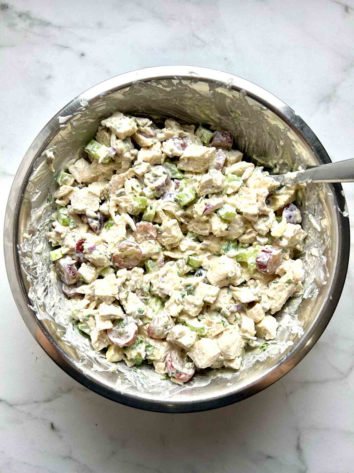 chicken salad mixed together in bowl.