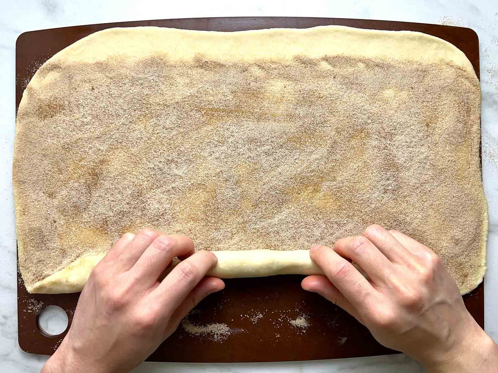 dough being rolled into log.