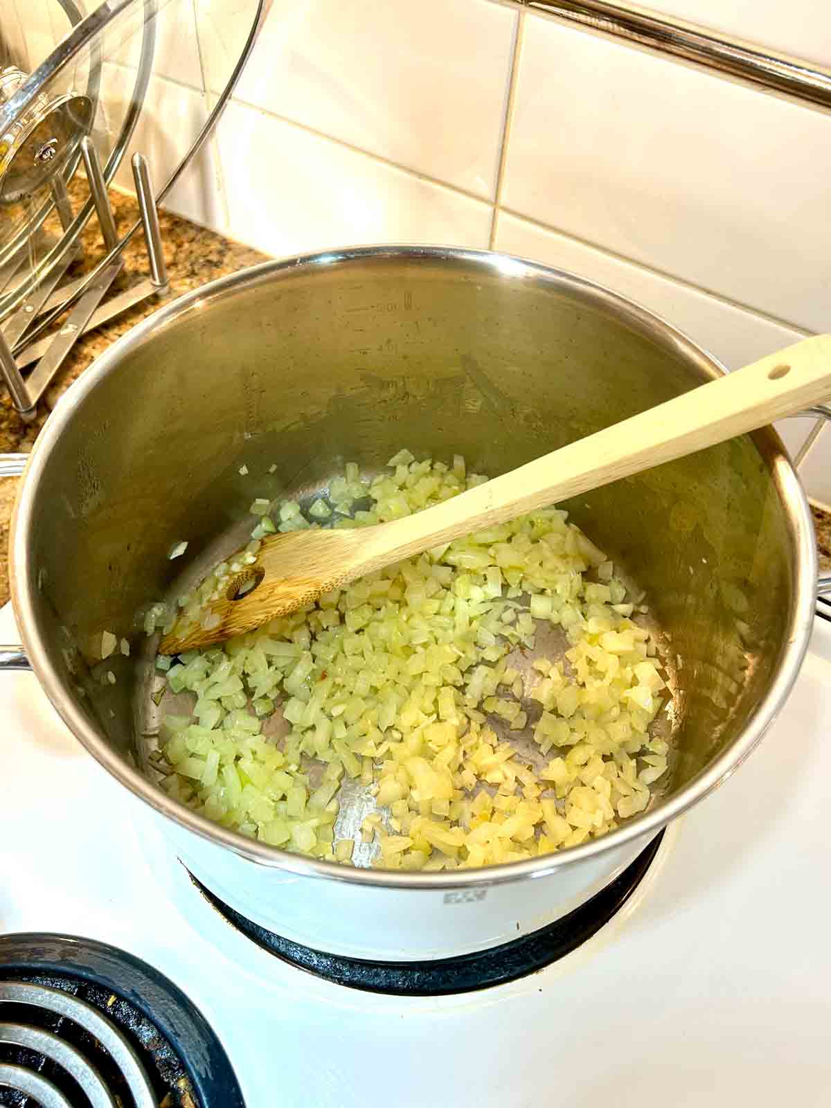 onions and garlic being cooked in pot.