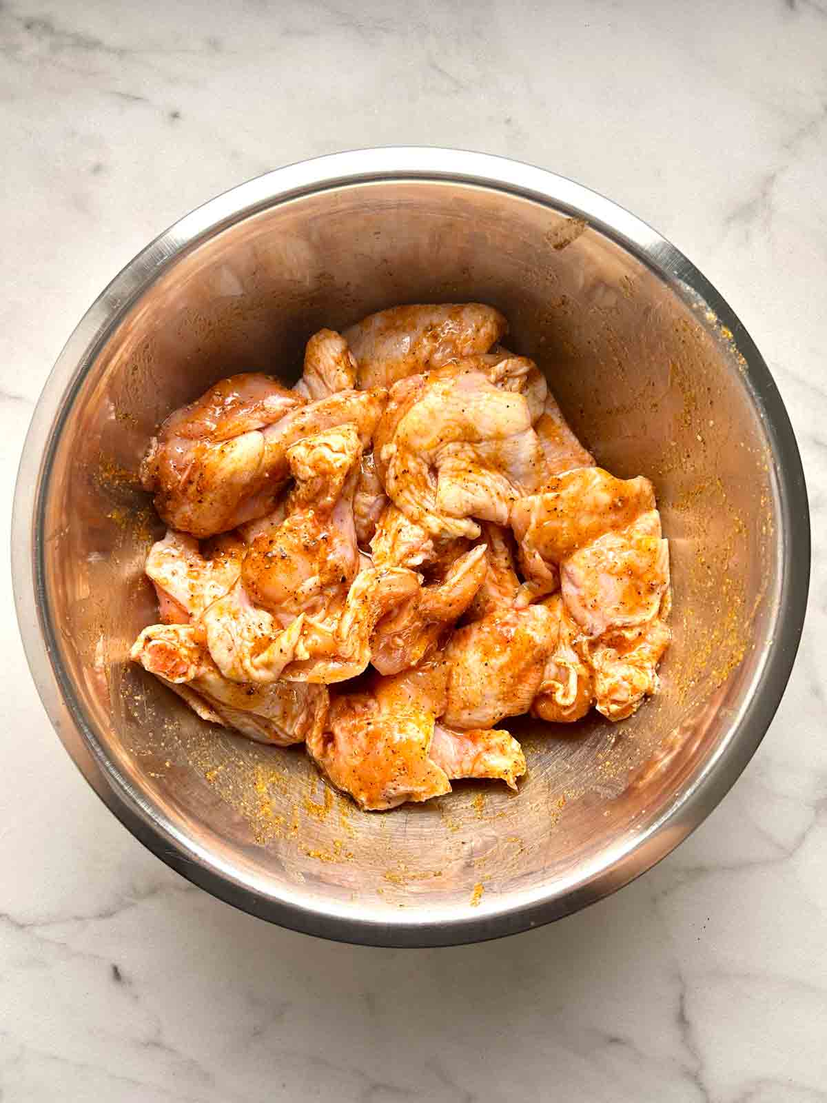 chicken wings mixed with olive oil and spices.