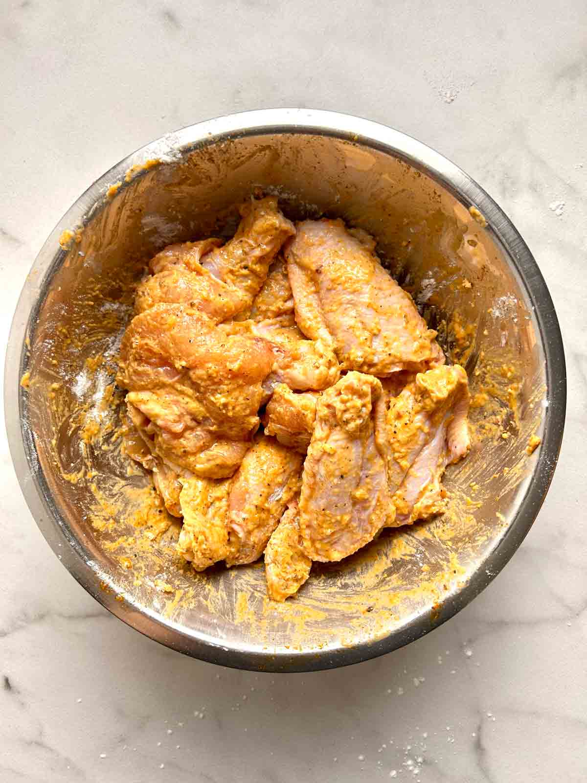 cornstarch and flour mixed with chicken wings.