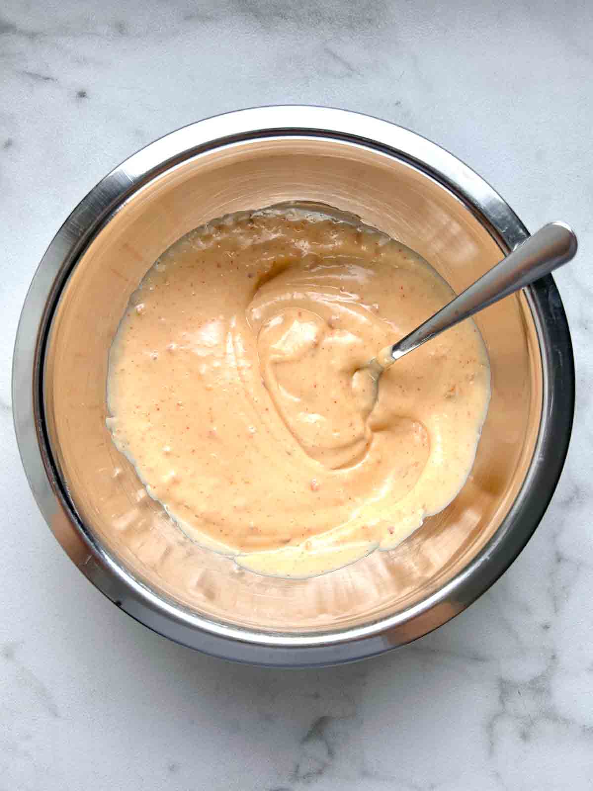 bang bang sauce being mixed in bowl.