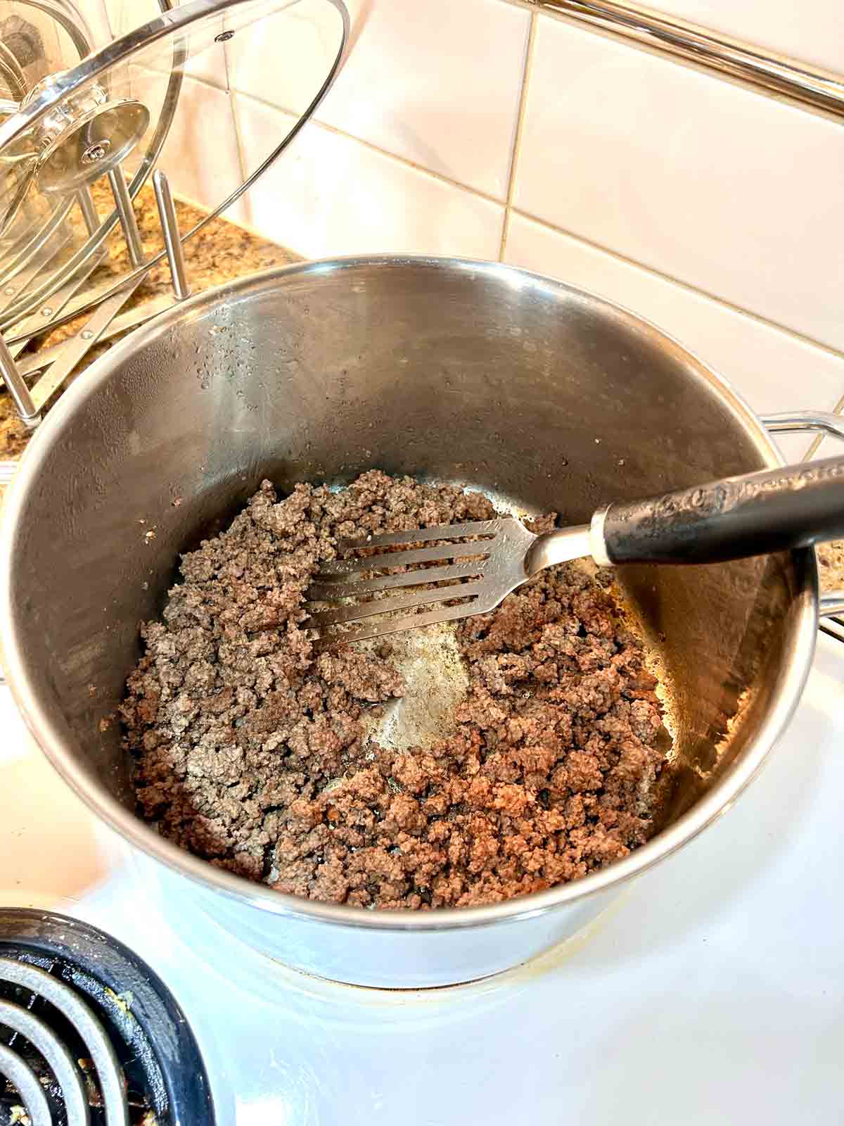 ground beef being cooked in pot.