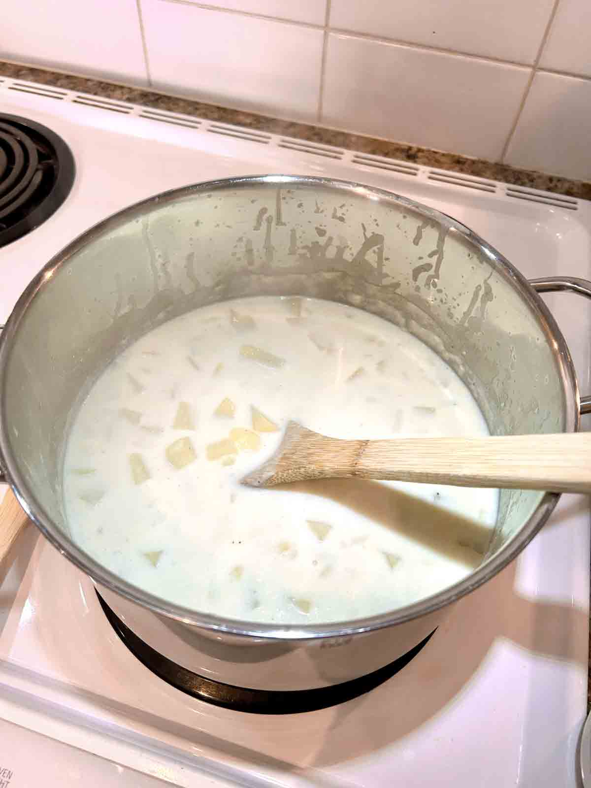 add milk, chicken stock, and potatoes.