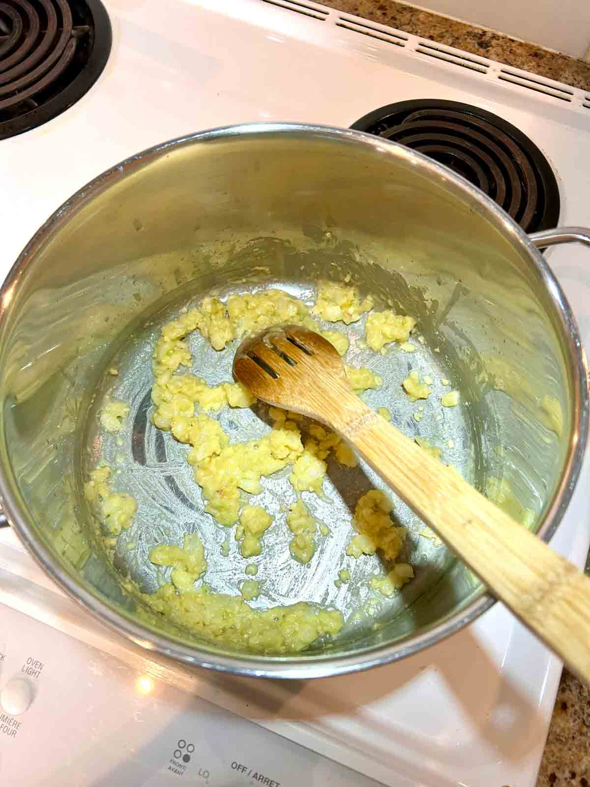flour being stirred into pot.