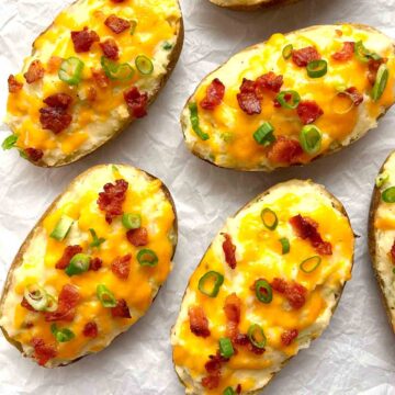 overhead shot of twice baked potatoes on crinkled parchment paper.