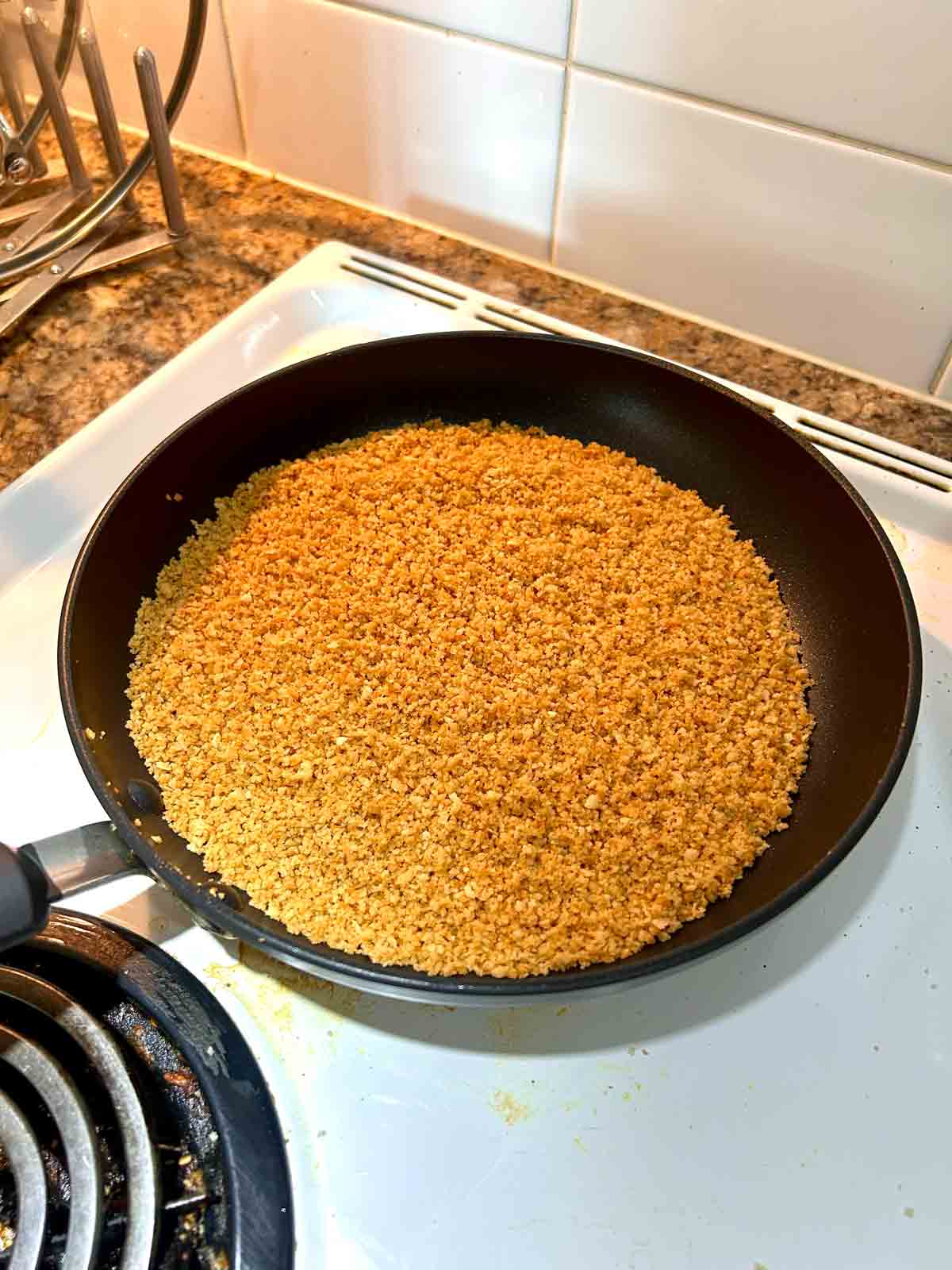 breadcrumbs being toasted in pan.