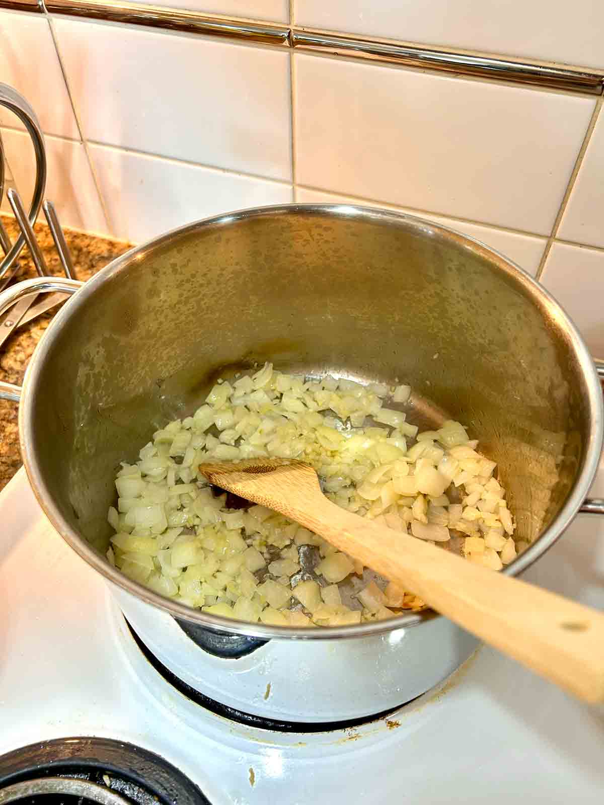 onions and garlic being sautรฉed in pot.