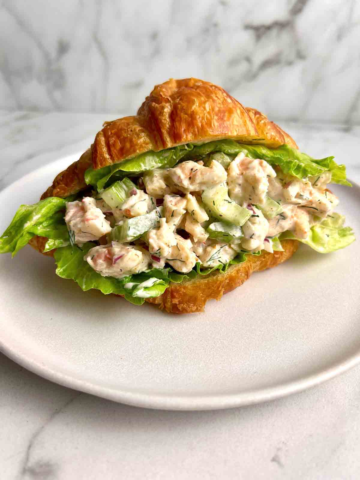 chopped shrimp salad in croissant.