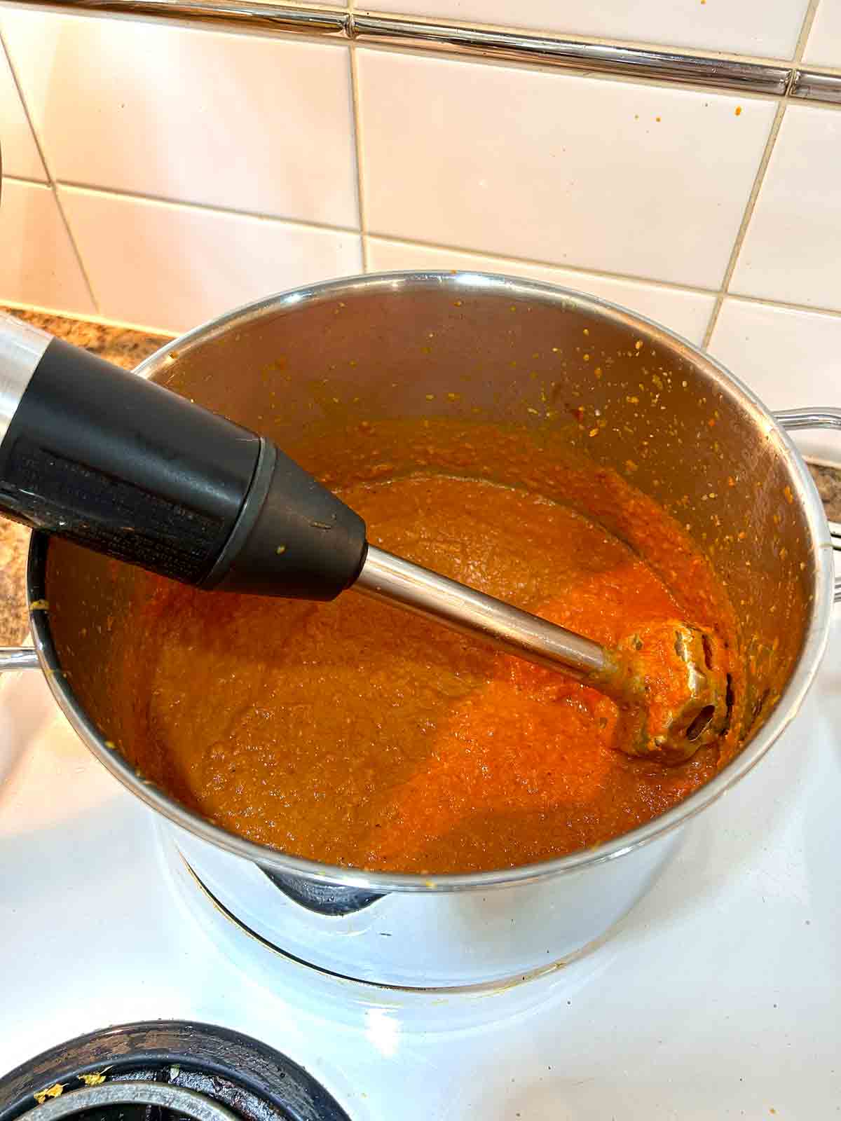 sauce being pureed in pot.