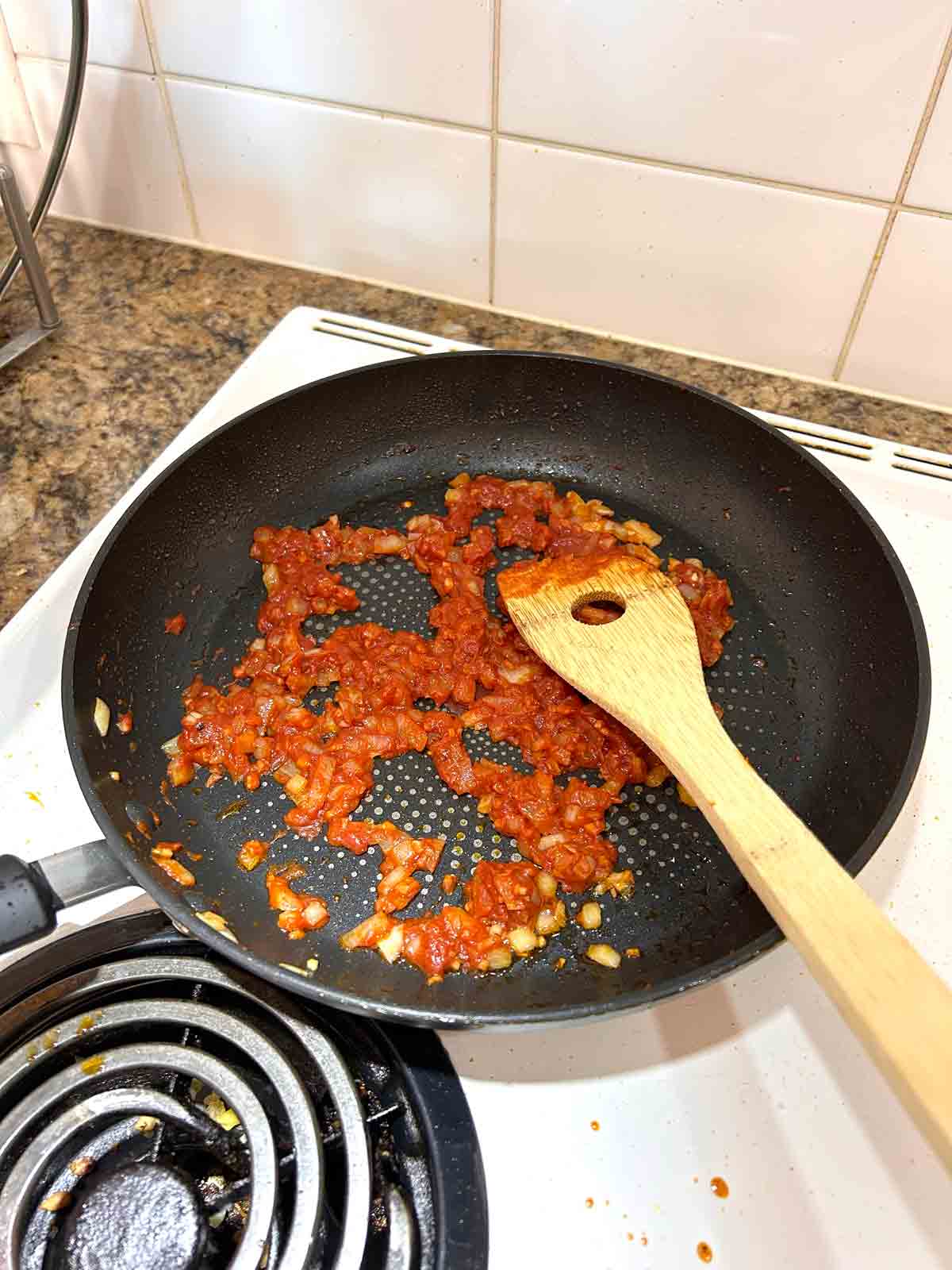 tomato paste added to pan.
