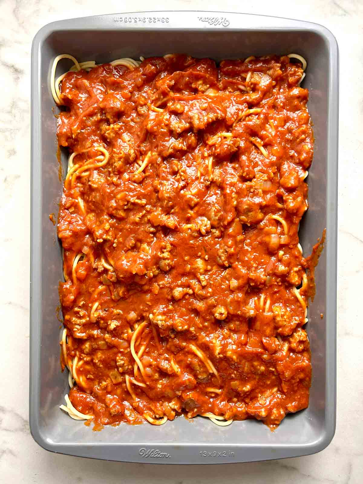 half of meat sauce added to casserole.