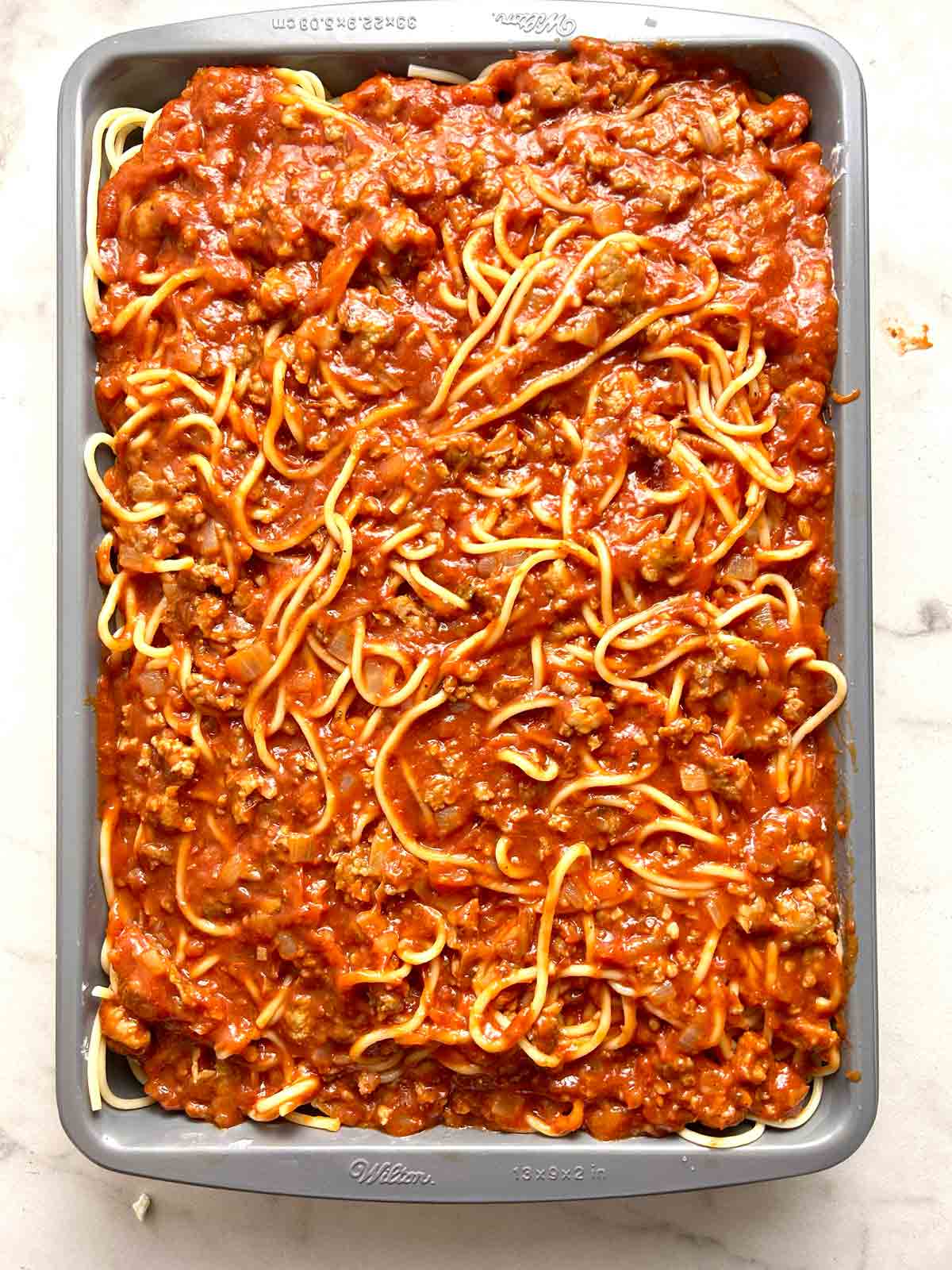 remaining meat sauce and spaghetti added to casserole.