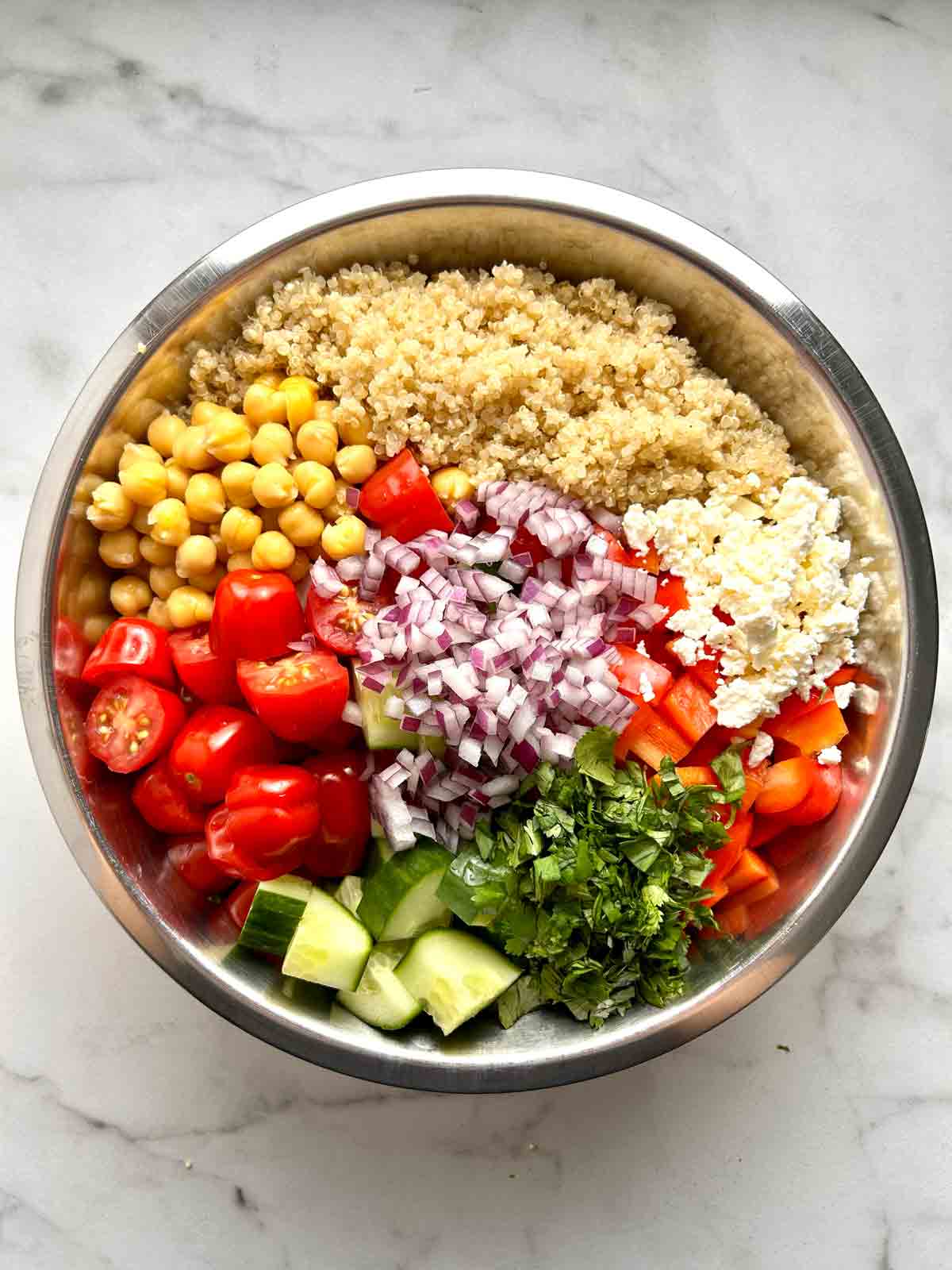 quinoa salad components in large bowl.