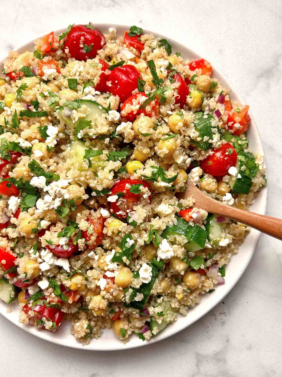 plate of quinoa salad with spoon in it.