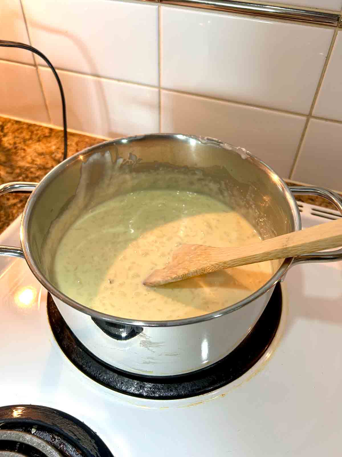 egg mixture being stirred into rice pudding.