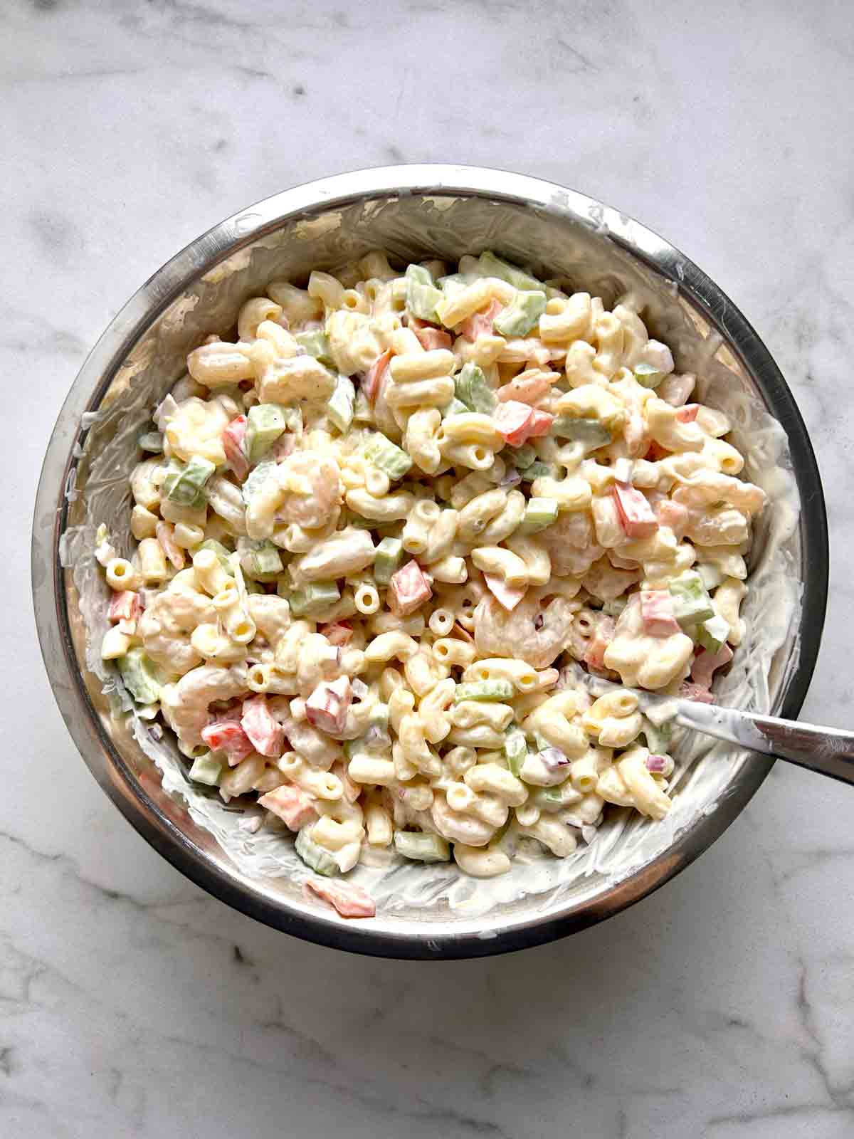 shrimp pasta salad mixed in bowl.