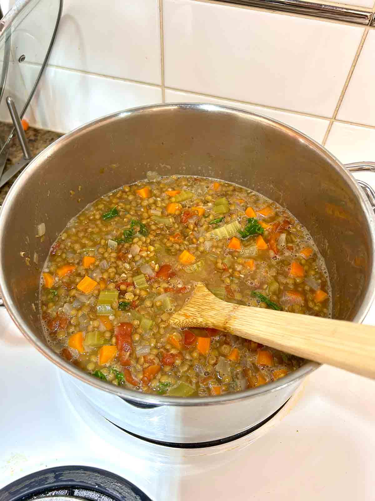 kale and lemon juice stirred into lentil soup.
