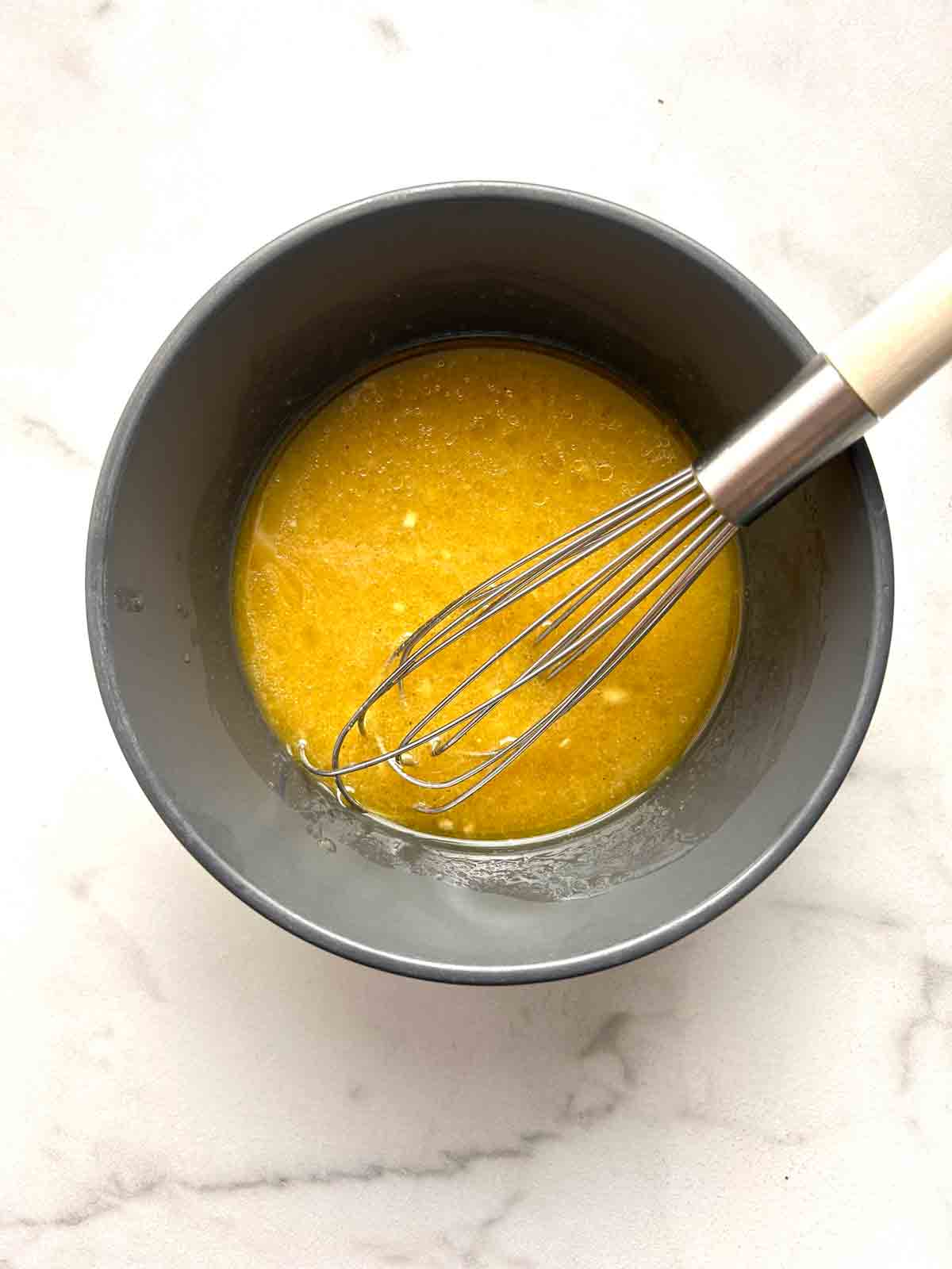 dressing ingredients whisked in bowl.