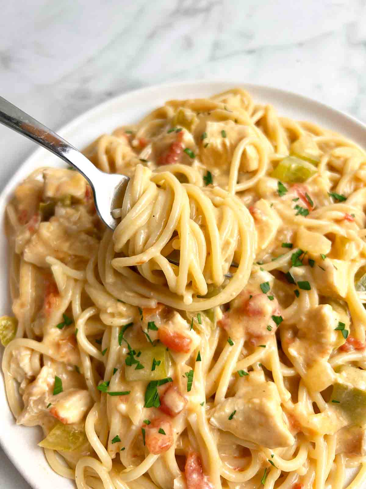 fork twirling chicken spaghetti onto it.