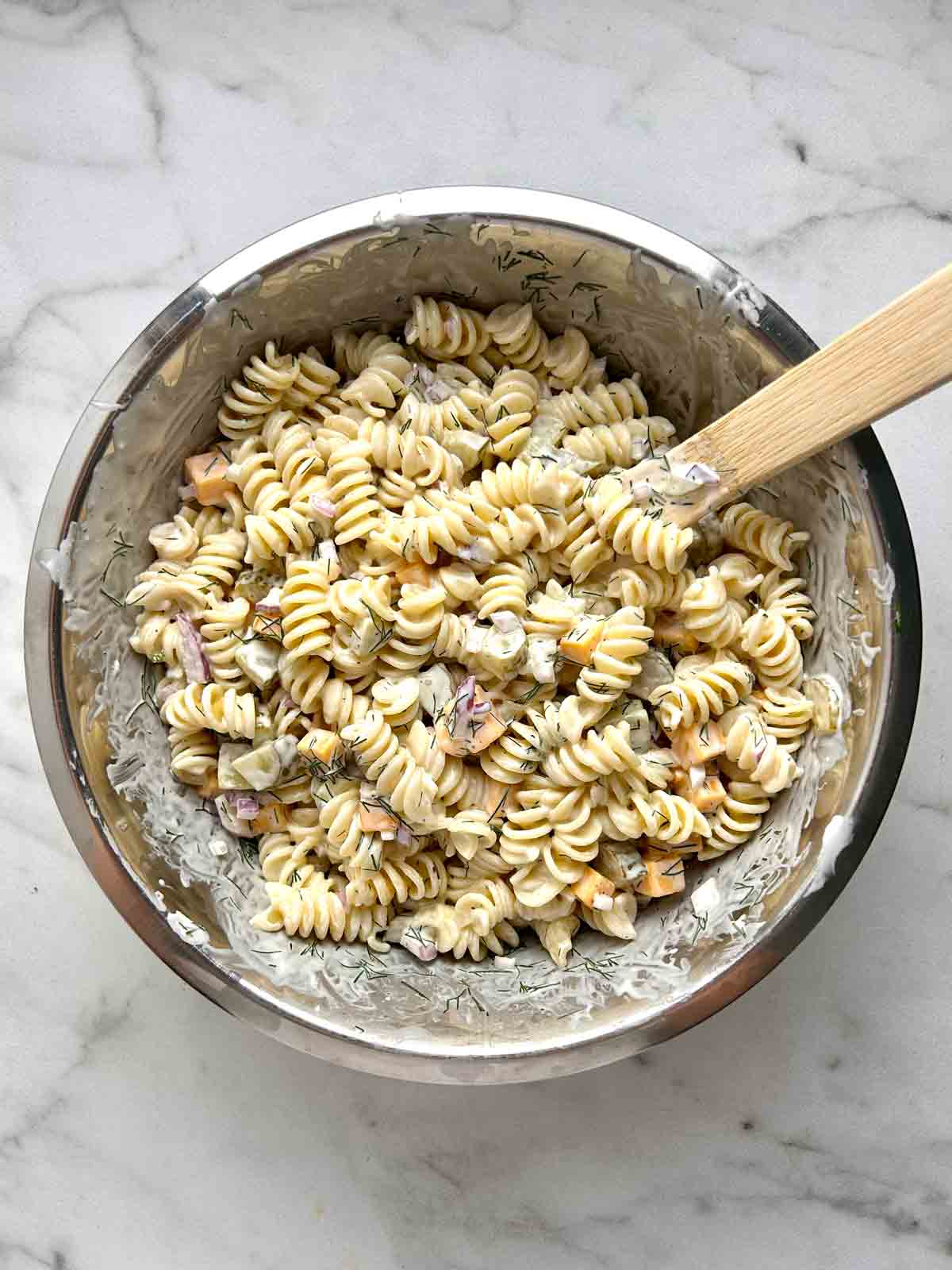 pasta salad mixed together in bowl.