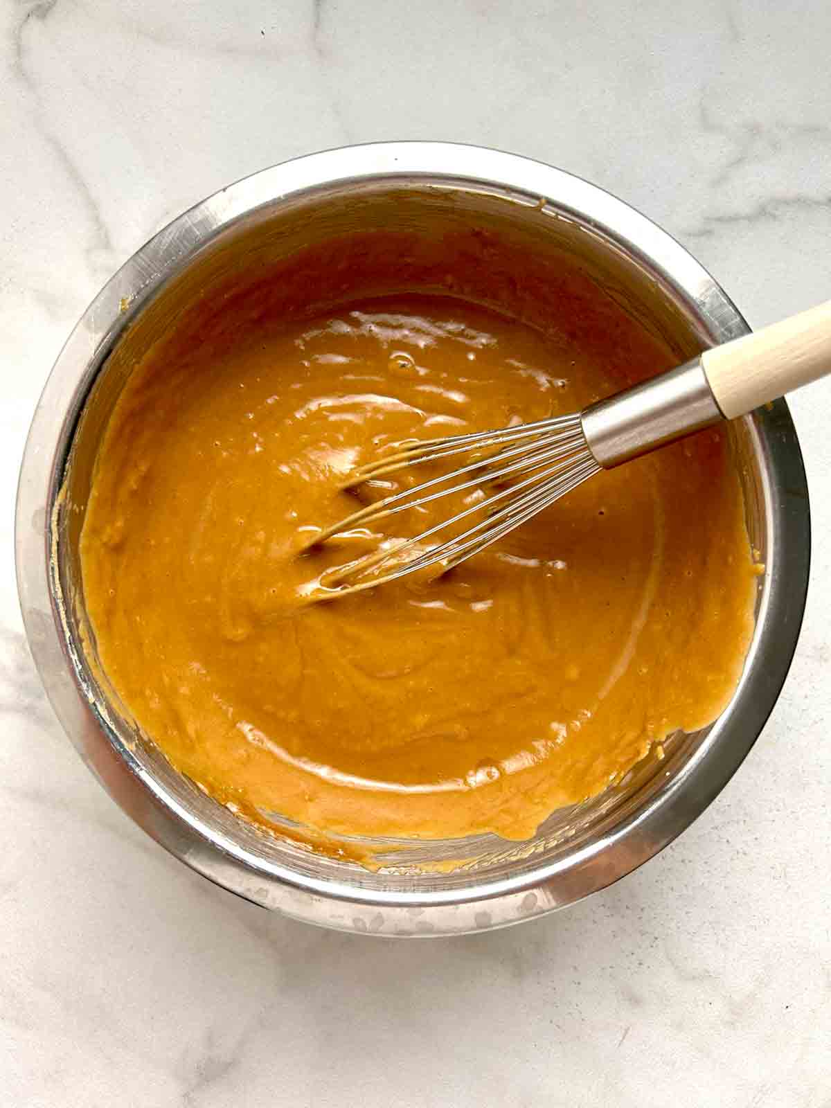 water whisked into sauce; sauce looks creamier.