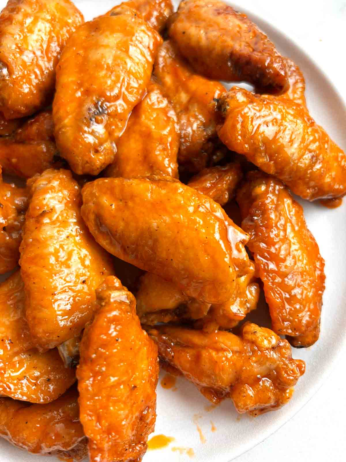 close up of buffalo wings on plate.
