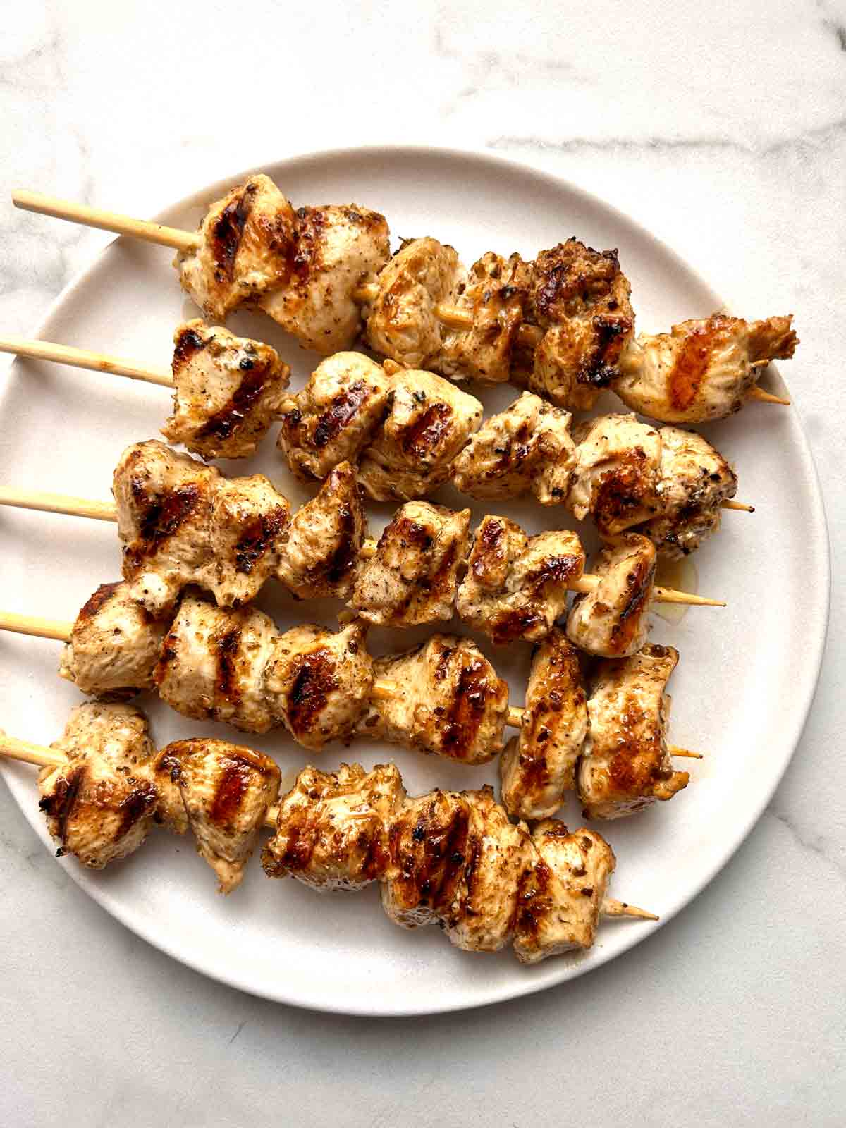 chicken souvlaki skewers on plate.