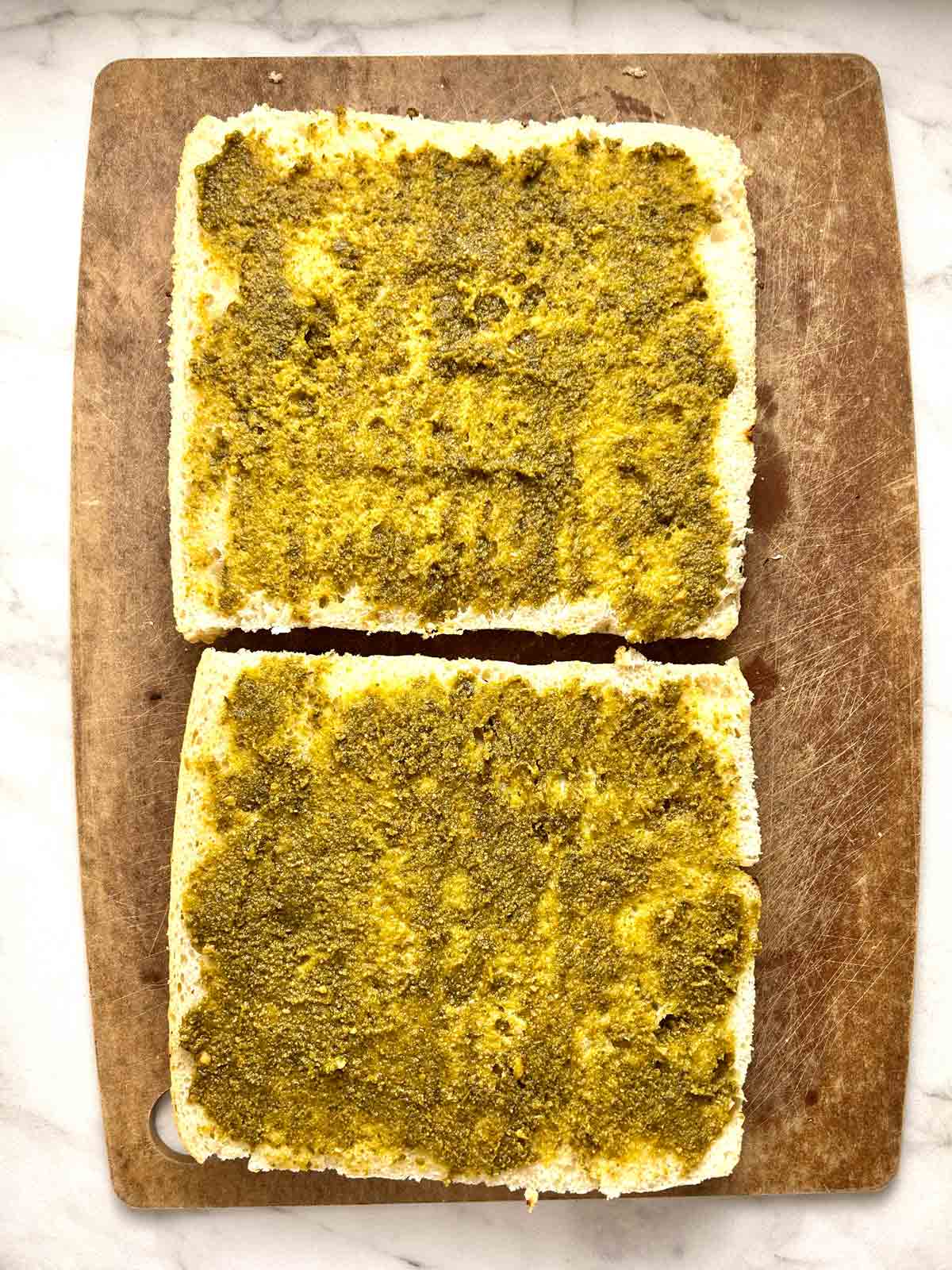 pesto spread on focaccia halves.