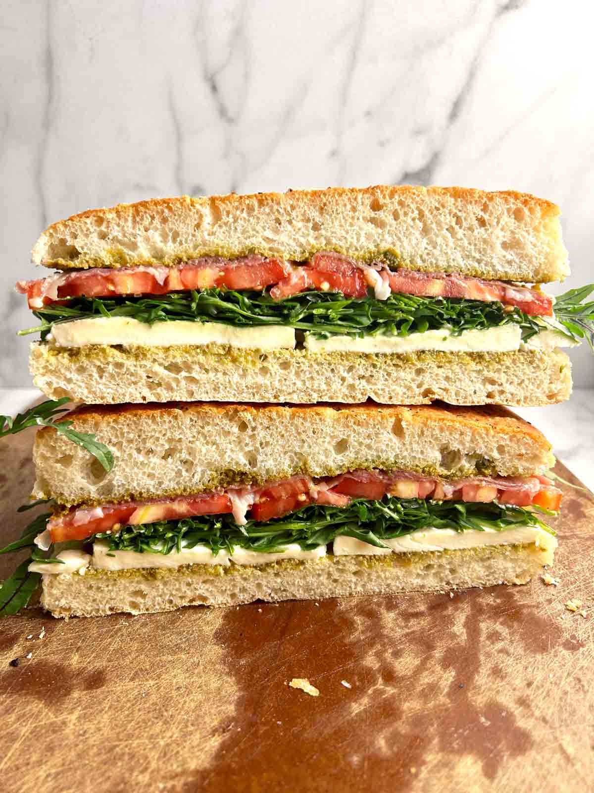 focaccia sandwich cut in half and stacked on top of each other.