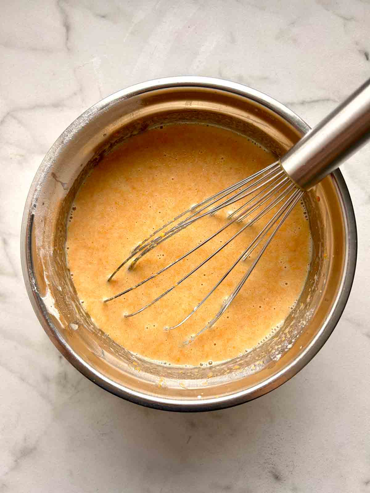 wet ingredients whisked in bowl.