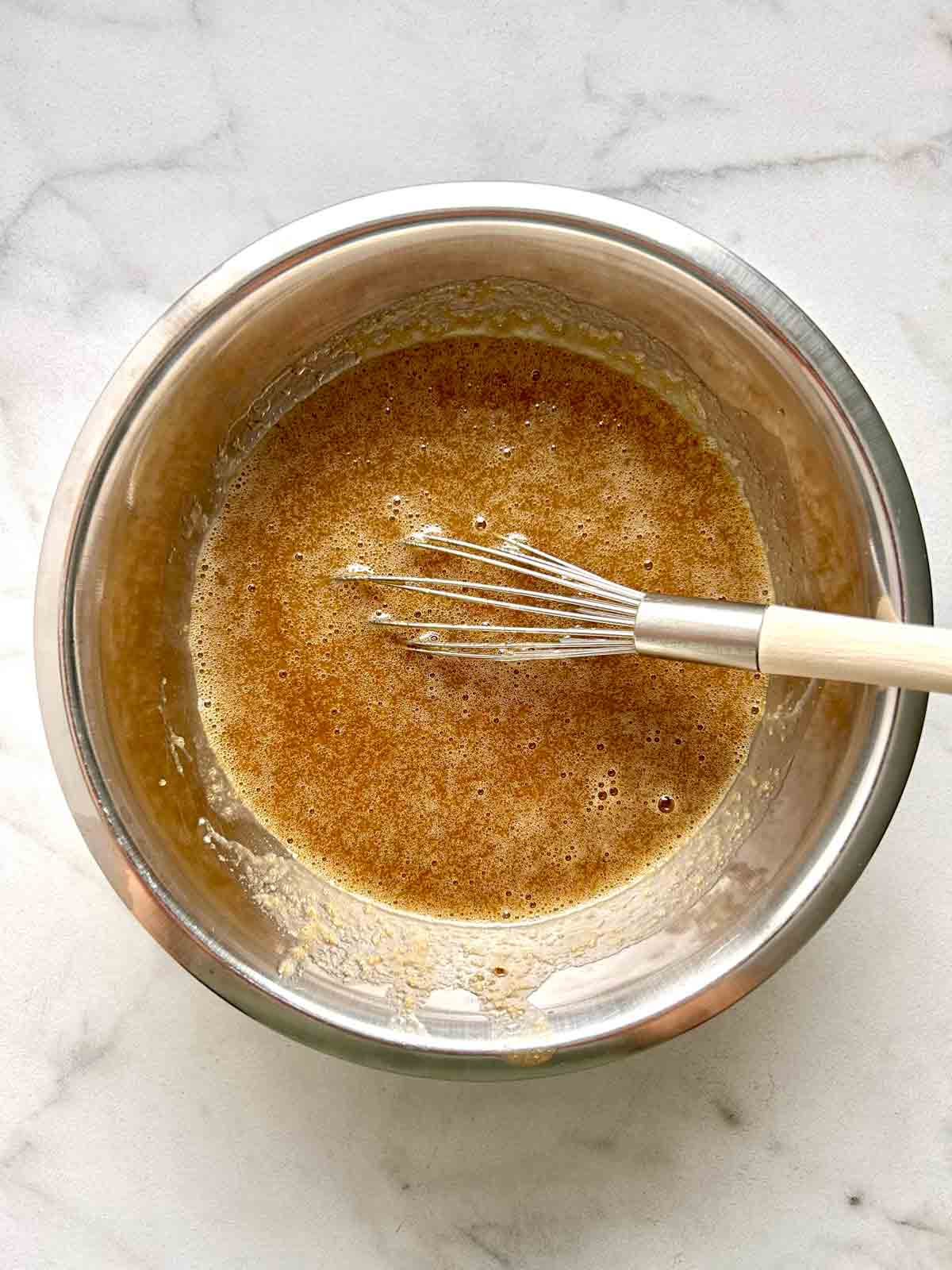 wet ingredients whisked in bowl.