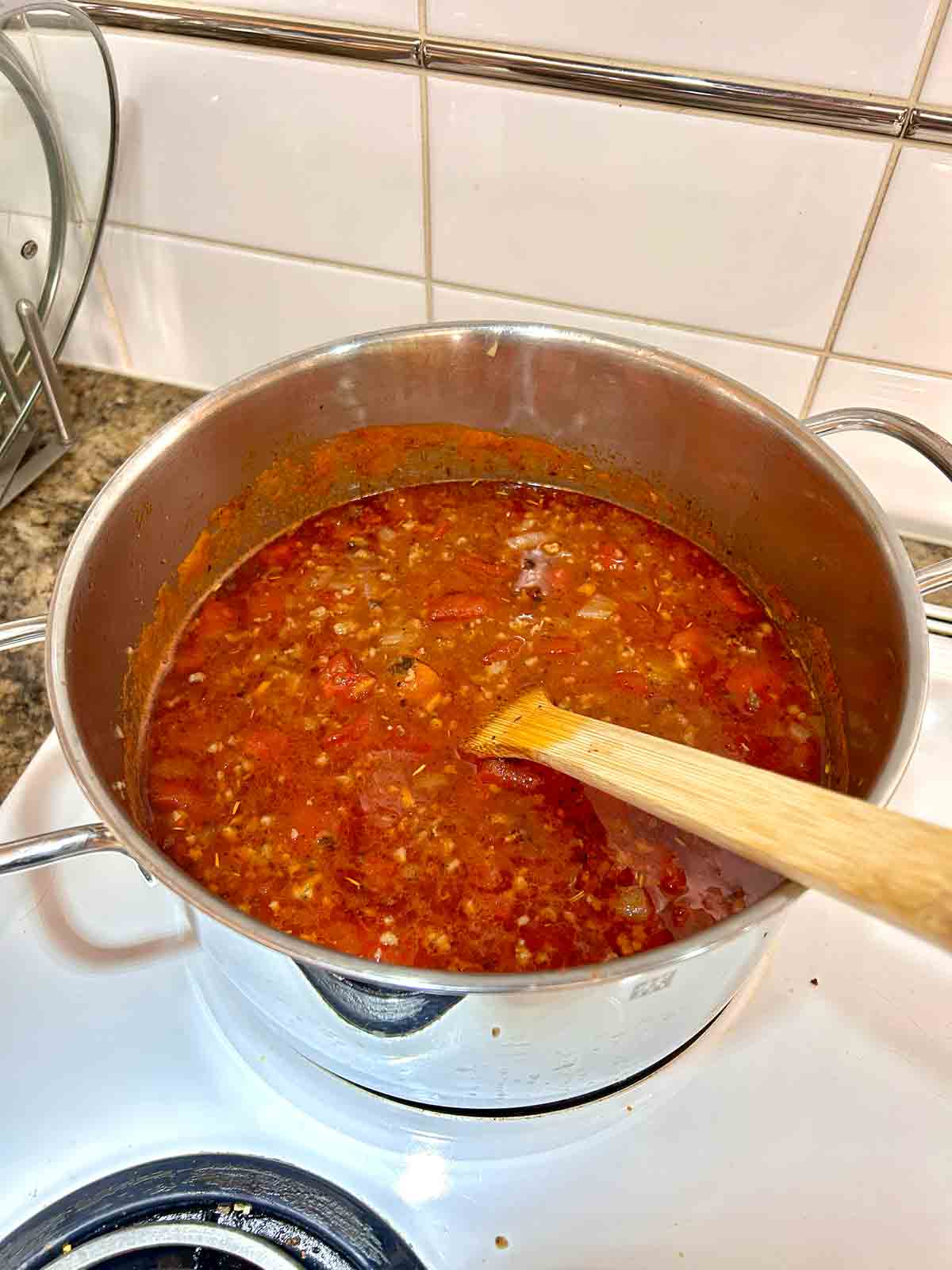 chicken stock, diced tomatoes, and seasonings added to broth.