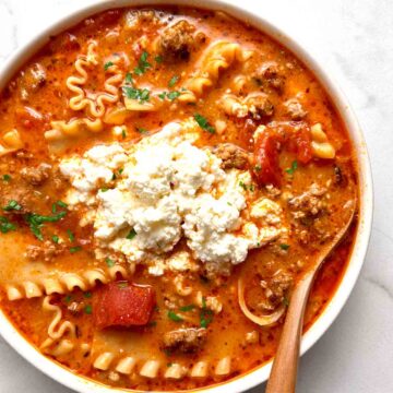 bowl of lasagna soup with scoop of ricotta cheese on top.