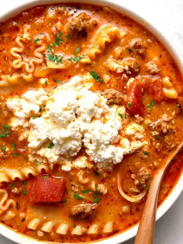 bowl of lasagna soup with scoop of ricotta cheese on top.